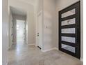 Modern entryway featuring gray tile flooring, white walls, and an exterior glass panel door at 16405 N Cobblestone Ln, Fountain Hills, AZ 85268