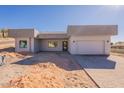 Modern home exterior with a clean design, gray tones, block wall, paved driveway, and desert landscaping at 16405 N Cobblestone Ln, Fountain Hills, AZ 85268