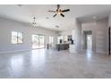 Spacious living room area overlooking the kitchen featuring tile floors, neutral walls and modern fixtures at 16405 N Cobblestone Ln, Fountain Hills, AZ 85268