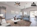 Inviting living room with stylish seating arrangement, contemporary decor, and view into the adjacent dining area at 16405 N Cobblestone Ln, Fountain Hills, AZ 85268