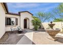 Cozy front courtyard with chairs, a fountain, and beautiful landscaping at 17002 S 178Th Ave, Goodyear, AZ 85338