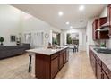 Bright open kitchen featuring an island, granite countertops, and a view of the living area and dining space at 1874 E Crescent Way, Chandler, AZ 85249
