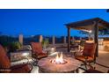 Relaxing outdoor firepit area with comfortable seating, a built-in grill, and a pergola-covered dining space at 1903 N Lynch --, Mesa, AZ 85207
