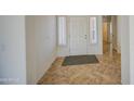 Bright foyer with tile flooring, a white front door, and sidelight windows at 2375 E Fiesta Dr, Casa Grande, AZ 85194