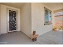 Welcoming entryway with decorative door, 'Welcome' mat, and whimsical welcome-bear, creating a warm first impression at 27391 W Wahalla Ln, Buckeye, AZ 85396