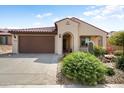 Inviting single-Gathering home with a well-manicured front yard and a two-car garage, showcasing great curb appeal at 27391 W Wahalla Ln, Buckeye, AZ 85396