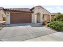 Attractive home featuring a large driveway and desert landscaping, plus neutral color palette adding to the appeal at 27391 W Wahalla Ln, Buckeye, AZ 85396