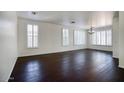 Spacious living room featuring dark hardwood floors and plantation shutters at 2982 E Boston St, Gilbert, AZ 85295