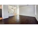 Bright living room showcasing dark hardwood floors, white walls, and staircase at 2982 E Boston St, Gilbert, AZ 85295
