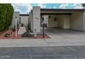Inviting single-story home featuring a covered parking area, cactus and desert landscaping at 3023 W Calavar Rd, Phoenix, AZ 85053