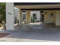 A single-story home featuring a covered parking area, cactus and desert landscaping at 3023 W Calavar Rd, Phoenix, AZ 85053