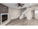 Spacious living room with fireplace, staircase, and wood flooring throughout at 3030 N Hayden Rd # 16, Scottsdale, AZ 85251