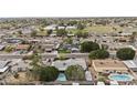 Expansive aerial view of a residential neighborhood with well-maintained homes and green spaces at 3802 W Rue De Lamour Ave, Phoenix, AZ 85029
