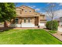 Beautiful two-story home with lush green lawn, mature trees, and a three-car garage at 38397 N Nuevo Laredo Ln, San Tan Valley, AZ 85140