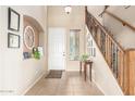 Inviting foyer with tile flooring, a staircase, and decorative accents at 38397 N Nuevo Laredo Ln, San Tan Valley, AZ 85140