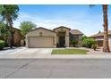 Charming single-Gathering home featuring a two-car garage, desert landscaping, and a cozy front entrance at 384 N Scott Dr, Chandler, AZ 85225