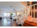 Open-concept living room with hardwood floors and staircase at 45176 W Alamendras St, Maricopa, AZ 85139