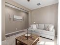Comfortable living room featuring neutral paint, tile entryway, carpet, and a plush sofa at 5259 S Hadron --, Mesa, AZ 85212