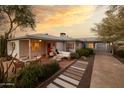 Charming home exterior with a brick patio, desert landscaping, and a cozy outdoor seating area at 536 W Windsor Ave, Phoenix, AZ 85003