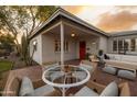 Charming front patio featuring outdoor dining and seating, complemented by mature trees and vibrant landscaping at 536 W Windsor Ave, Phoenix, AZ 85003