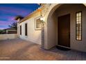Inviting covered front porch with a brick-paved walkway leading to the warm-toned front door at 8661 E Ivy St, Mesa, AZ 85207