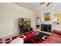 Comfortable living area with a television, modern decor, and a glimpse into an adjacent bedroom at 8661 E Ivy St, Mesa, AZ 85207