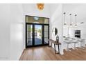 Bright open foyer with hardwood floors and views of the kitchen and front patio at 9627 E Gold Dust Ave, Scottsdale, AZ 85258