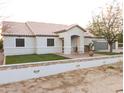 Well-maintained single-story home with a beautiful red tile roof, three-car garage, and stone wall feature at 9732 N Penworth Dr, Casa Grande, AZ 85122