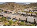 Aerial view of homes featuring tile roofs, desert landscaping, fenced in backyards with pools and mountain views at 1816 N Bernard Cir, Mesa, AZ 85207