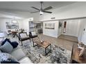Bright living room boasts modern furnishings, a ceiling fan, and seamlessly connects to the dining area at 2416 W Stottler Dr, Chandler, AZ 85224