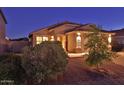 Inviting single-story home with a tile roof, two-car garage, and easy-care desert landscaping at twilight at 803 W Burkhalter Dr, San Tan Valley, AZ 85143