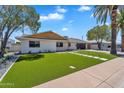 Charming single-story home featuring a well-manicured lawn and a modern exterior design at 8215 E Virginia Ave, Scottsdale, AZ 85257