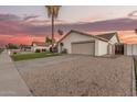Suburban home with desert landscaping, long driveway, and attached two-car garage at 8219 W Corrine Dr, Peoria, AZ 85381