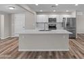 Modern kitchen featuring a large island, stainless steel appliances, and updated cabinets at 1112 W Farmdale Ave, Mesa, AZ 85210