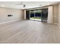 Large room with tile flooring and sliding glass doors providing access to the outdoor pool area at 11663 W Luxton Ln, Avondale, AZ 85323