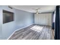 Spacious bedroom features modern laminate floors, large wardrobe and ample natural light at 1556 E Dover Cir, Mesa, AZ 85203