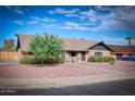 Lovely single-story brick home with well-manicured landscape and inviting front yard at 1556 E Dover Cir, Mesa, AZ 85203