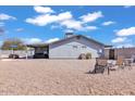 Spacious backyard featuring desert landscaping, covered patio, and outdoor seating areas at 15814 N 62Nd Cir, Glendale, AZ 85306