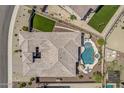 Aerial shot of a private residence showing a tiled roof, backyard pool, outdoor seating, and manicured desert landscaping at 18120 W Cassia Way, Goodyear, AZ 85338