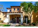 Inviting two-story home with a covered porch, stylish desert landscaping and a warm, welcoming facade at 21152 W Sunrise Ln, Buckeye, AZ 85396
