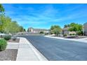 View of the neighborhood street and sidewalks, offering a glimpse of the community homes at 2116 E Beautiful Ln, Phoenix, AZ 85042