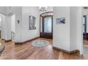 Elegant foyer featuring hardwood floors, an arched doorway, and intricate wrought iron door at 21470 E Orchard Ln, Queen Creek, AZ 85142