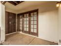 Enclosed patio featuring access door and an outdoor space with access to the interior through double doors at 2201 W Union Hills Dr # 119, Phoenix, AZ 85027