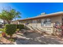View of the home's backyard with a small patio area and some landscaping features at 2306 E Burgess Ln, Phoenix, AZ 85042