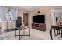 Inviting living room with a large television, modern furniture, and ample space at 2306 E Burgess Ln, Phoenix, AZ 85042