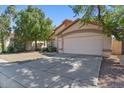 Well-maintained single-story home featuring a two-car garage and manicured lawn at 2313 E Gondola Ln, Gilbert, AZ 85234