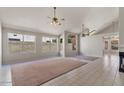 Spacious living room featuring tile floors, a fireplace, vaulted ceilings, and bright windows at 2313 E Gondola Ln, Gilbert, AZ 85234