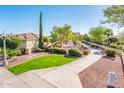 A nicely landscaped walking path winds through a quiet neighborhood on a bright day at 23216 N Gaviota Dr, Sun City West, AZ 85375