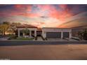 Beautifully landscaped home with a terracotta roof, ornate entry door, and two-car garage at 2421 E Montebello Ave, Phoenix, AZ 85016