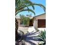 Charming single-story home featuring desert landscaping and a two-car garage at 2424 E Aster Dr, Phoenix, AZ 85032